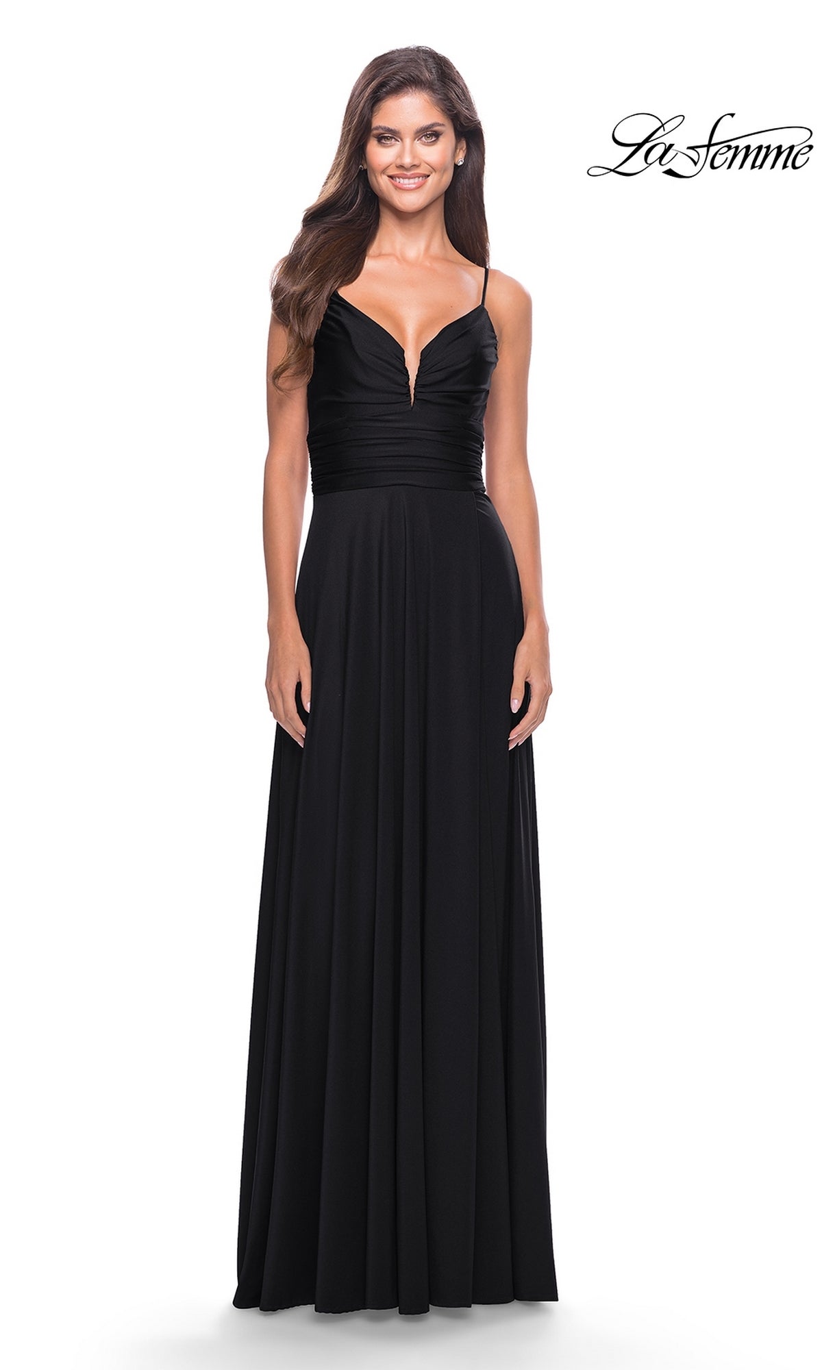 A woman models the La Femme Simple Long A-Line Prom Dress 31090, featuring thin straps, a deep V-neckline, and a ruched bodice. She stands against a white background with the La Femme logo in the top right corner.